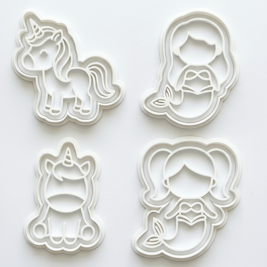 Set of four cookie cutters shaped like a unicorn, fairy, and two other designs on a white background.